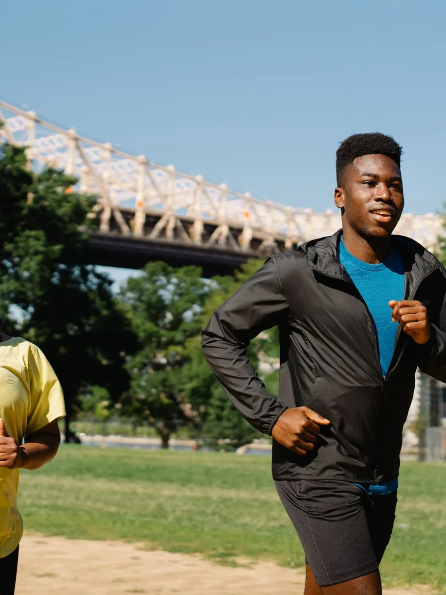 Energetic couple jogging together outdoors in a park
