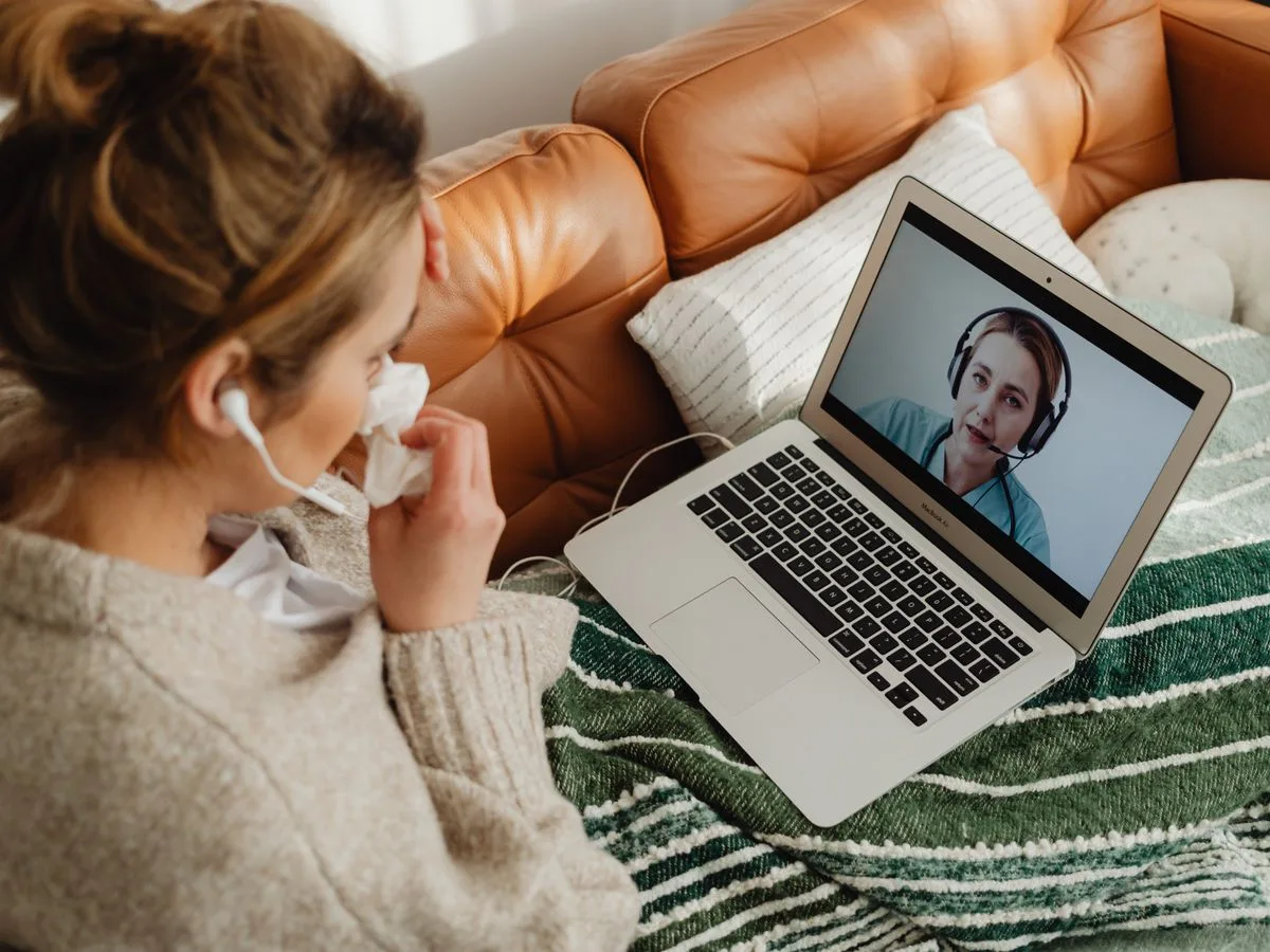 Woman having an online consultation with her practitioner on a laptop