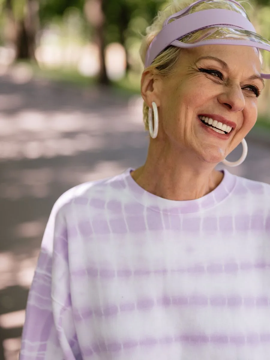 Smiling mature woman enjoying a sunny day outdoors